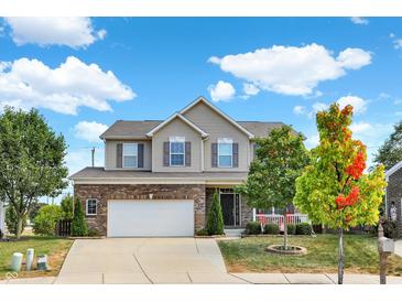 Charming two-story home featuring a brick facade and a well-manicured front yard on a sunny day at 14095 Northcoat Pl, Fishers, IN 46038