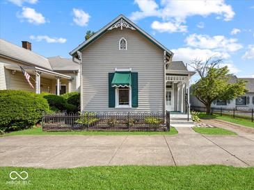 Charming home featuring a decorative front door and well-maintained landscaping at 146 E Broadway St, Shelbyville, IN 46176