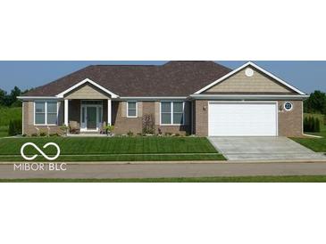 Charming brick home with a well-manicured lawn and attached two car garage at 204 St Andrews Ave, Edinburgh, IN 46124