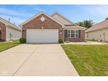 Charming single-story brick home featuring an attached two-car garage and well-maintained front lawn at 882 Lincoln Park W Dr, Greenwood, IN 46142