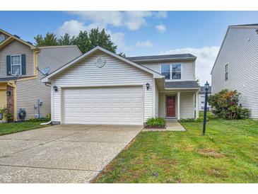 Charming two-story home with a well-maintained lawn and a two-car garage at 10246 Liverpool Way, Indianapolis, IN 46236