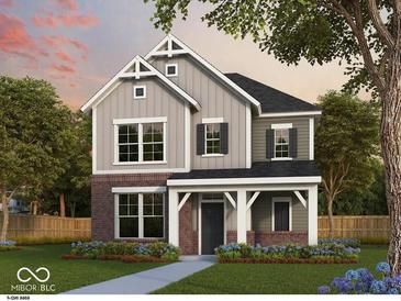 Charming two-story home with gray siding, brick accents, and a welcoming covered porch at 12210 Vera Ct, Noblesville, IN 46060