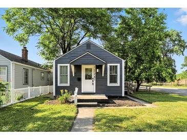 Charming single-story home with blue siding, white trim, landscaped yard, and a sidewalk leading to the front door at 1324 E 9Th, Indianapolis, IN 46202