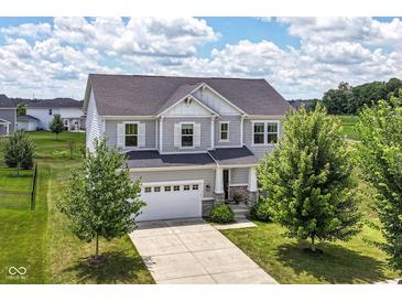 Beautiful two-story home featuring a well-manicured lawn, a two-car garage and traditional architectural details at 15984 Conductors Dr, Westfield, IN 46074