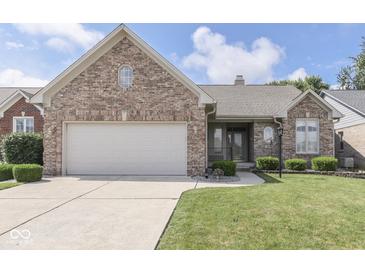 Beautiful brick home with a well-maintained lawn and attached two-car garage at 1645 Oakmere Way, Greenwood, IN 46142