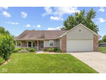 Charming one-story home with a well-manicured lawn and an attached two-car garage at 31 Morningside Ct, Whiteland, IN 46184