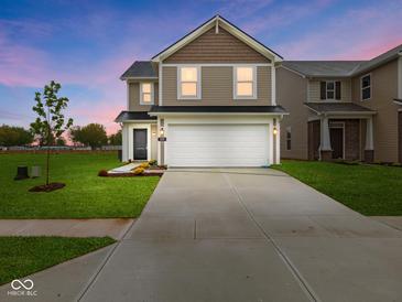 Inviting two-story home featuring a pristine lawn, neutral siding, and a spacious two-car garage at 3142 Lennon Ln, Indianapolis, IN 46235