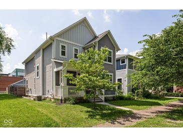 Two-story home showcasing well-maintained landscaping and a charming covered front porch at 630 Dorman St, Indianapolis, IN 46202
