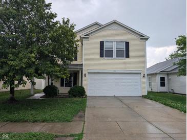Traditional two-story home with a two-car garage and neutral color palette at 908 Belvedere Dr, Shelbyville, IN 46176