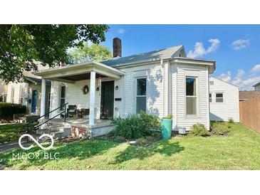 Charming home with a covered porch and well-maintained front yard at 909 Pearl St, Columbus, IN 47201