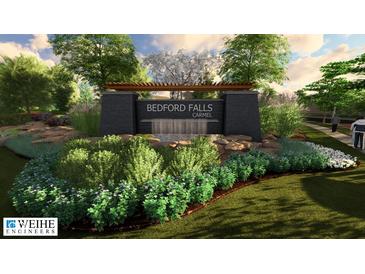 An entrance to a neighborhood with a stone sign and landscaped garden at 14565 Bedford Falls Dr, Carmel, IN 46032