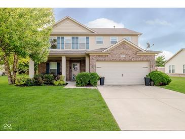 Charming two-story home with a well-manicured lawn and attached two-car garage at 20846 Winding Lake E Dr, Noblesville, IN 46062