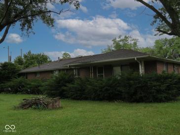 Single-story brick home with well-maintained landscaping and a beautiful yard at 3103 Westenedge Dr, Columbus, IN 47203