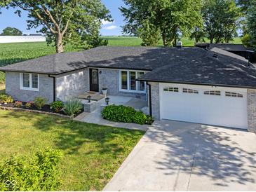Charming ranch home featuring a brick exterior, well-manicured lawn, and an attached two-car garage at 3777 W State Road 234, McCordsville, IN 46055