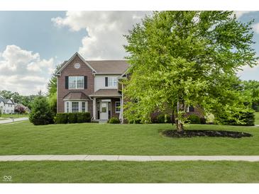 Lovely two-story brick home with a well-maintained lawn and mature trees at 4150 Huntsman Dr, Zionsville, IN 46077