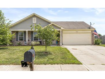 Charming single-Gathering home with a well-manicured lawn and attached two-car garage at 5865 Pennekamp Dr, Plainfield, IN 46168