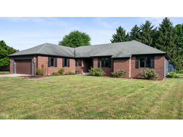 Beautiful brick home with an attached garage and well manicured front lawn at 180 Wellington Pkwy, Noblesville, IN 46060