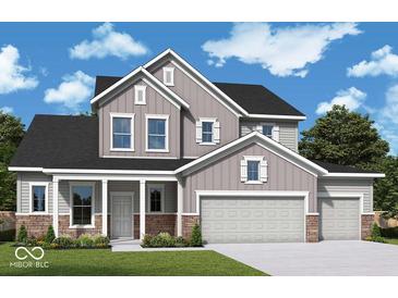 Charming two-story home with stone accents, a three-car garage and manicured lawn at 19796 Chatham Shore Ln, Westfield, IN 46074