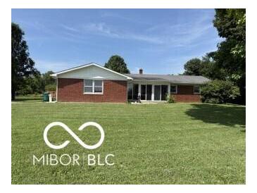 Charming brick ranch home with well-maintained lawn and mature trees on a sunny day at 4680 Cartersburg Rd, Plainfield, IN 46168
