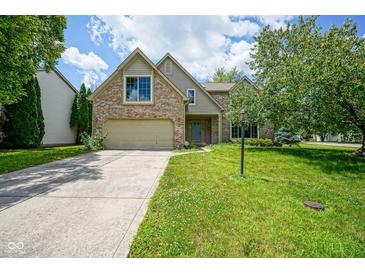 Charming brick two-story home with well-maintained lawn and attached two car garage at 5640 Dapple Ct, Indianapolis, IN 46228