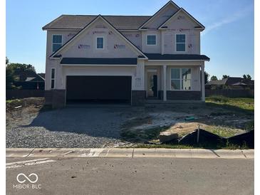 Charming two-story home with a front-entry two-car garage and covered entry at 3110 Montgomery Blvd, Lapel, IN 46051