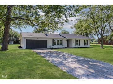 Charming single-story home with a well-manicured lawn and a long driveway at 3120 S Meridian Rd, Greenfield, IN 46140