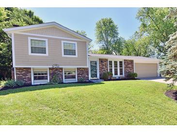 Charming two-story home with a brick facade and a well-manicured lawn at 524 Concord Ct, Fishers, IN 46038