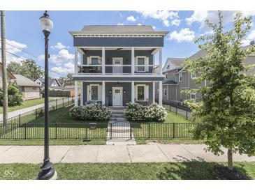 Charming two-story home with a double-decker porch, fenced yard, and manicured landscaping at 847 E Jefferson St, Franklin, IN 46131