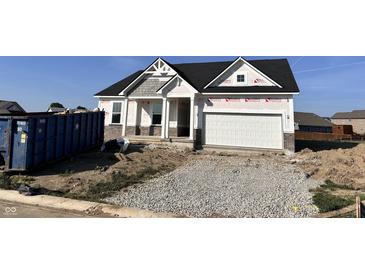 New construction home featuring a two-car garage and a partially graveled driveway at 9417 Crimson Cir, Lapel, IN 46051