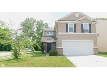Charming two-story home featuring tan siding, a two-car garage, and a well-maintained front lawn at 11445 Congaree Way, Indianapolis, IN 46235