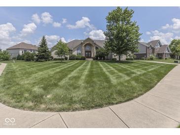 Charming home with a manicured lawn, mature trees, and an inviting entrance, set against a backdrop of blue skies and puffy clouds at 3270 Cherokee Cir, Bargersville, IN 46106