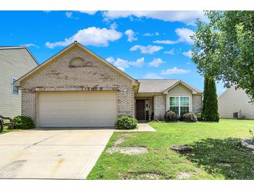 Charming one-story brick home with an attached two-car garage and well-maintained front yard at 6383 Enclave Blvd, Greenwood, IN 46143