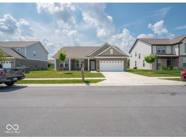 Inviting one-story home featuring a brick facade, attached two-car garage, and well-manicured front lawn at 7241 Glen Park Ln, Indianapolis, IN 46259