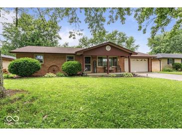 Charming single-story brick home with a well-manicured lawn and a cozy front porch at 3331 Loral Dr, Anderson, IN 46013