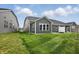 Well-manicured lawn in the backyard with gray siding and white trim at 16969 Cole Evans Dr, Noblesville, IN 46060