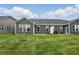 Backyard of home featuring an expansive lawn and dark gray siding at 16969 Cole Evans Dr, Noblesville, IN 46060