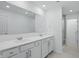 Bright bathroom featuring a double vanity with sleek fixtures, framed mirror, and a glass-enclosed shower at 16969 Cole Evans Dr, Noblesville, IN 46060