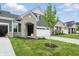 Attractive home featuring stone accents, neutral siding, a two car garage and well maintained lawn at 16969 Cole Evans Dr, Noblesville, IN 46060