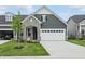 Charming home featuring stone accents, neutral siding, manicured lawn, and an attached two car garage at 16969 Cole Evans Dr, Noblesville, IN 46060