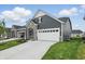 Attractive home featuring stone accents, neutral siding, a two car garage, and a well maintained lawn at 16969 Cole Evans Dr, Noblesville, IN 46060