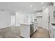 The kitchen island features neutral countertops, stainless appliances, and white cabinets at 16969 Cole Evans Dr, Noblesville, IN 46060