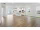 Open living space and kitchen featuring hardwood floors, neutral paint, and natural light at 16969 Cole Evans Dr, Noblesville, IN 46060