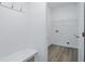 Mudroom featuring wood-style flooring, coat hooks, a storage bench, and a utility sink hookup at 16969 Cole Evans Dr, Noblesville, IN 46060