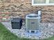 Exterior view of a Carrier air conditioning unit with brick background at 2892 S State Road 267, Plainfield, IN 46168