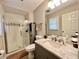 Bathroom featuring a glass-enclosed shower, modern vanity with a marble countertop, and updated fixtures at 2892 S State Road 267, Plainfield, IN 46168