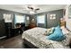 Comfortable bedroom featuring a ceiling fan, a queen bed, a desk, and warm wood-look flooring at 2892 S State Road 267, Plainfield, IN 46168