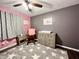 Sweet Bedroom featuring a rocking chair, changing table, dresser, and star-patterned rug at 2892 S State Road 267, Plainfield, IN 46168