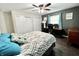 Comfortable bedroom featuring a ceiling fan, a queen bed, a desk, and warm wood-look flooring at 2892 S State Road 267, Plainfield, IN 46168