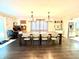 Large dining room with long table, hardwood floors, and modern lighting at 2892 S State Road 267, Plainfield, IN 46168