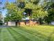 Charming brick home with manicured front lawn and mature trees at 2892 S State Road 267, Plainfield, IN 46168